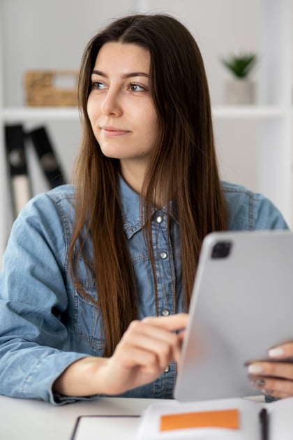 medium-shot-smiley-woman-holding-tablet
